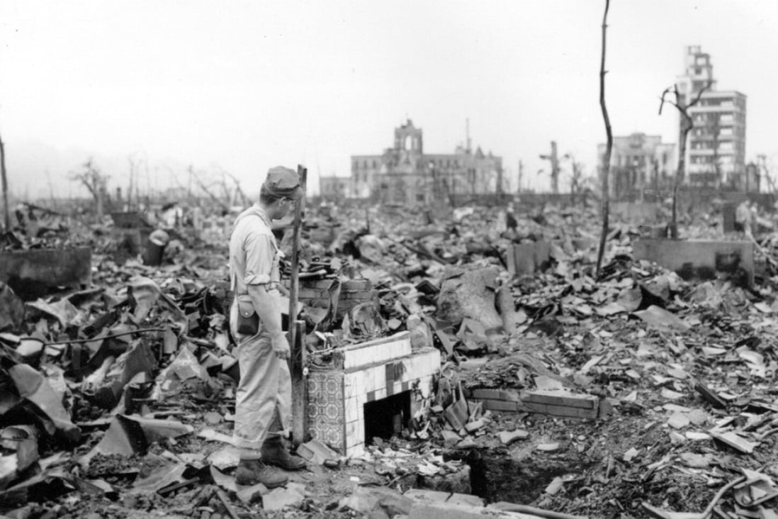 A man stands next to a tiled fireplace where a house once stood in Hiroshima, Japan. File photo: AP