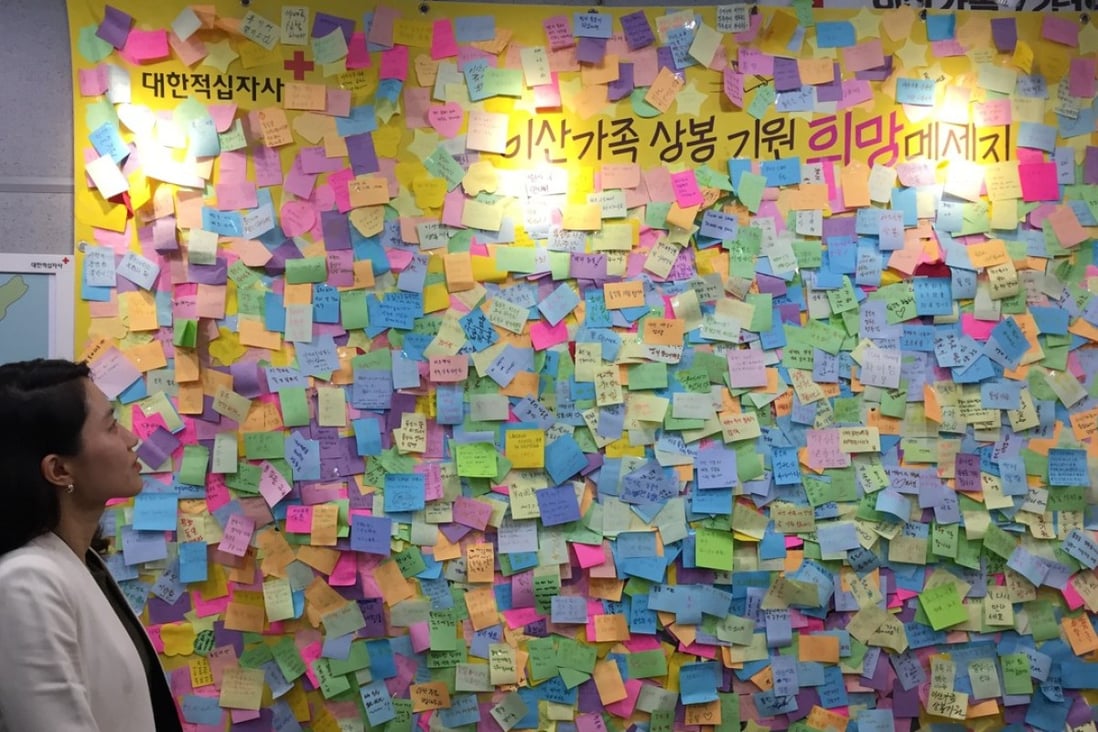 Jung Ja-eun, head of the inter-Korean cooperation team at the Korean Red Cross, looks at a wall of notes left behind by international visitors and separated families inside the organisation’s video reunion room. Photo: Crystal Tai