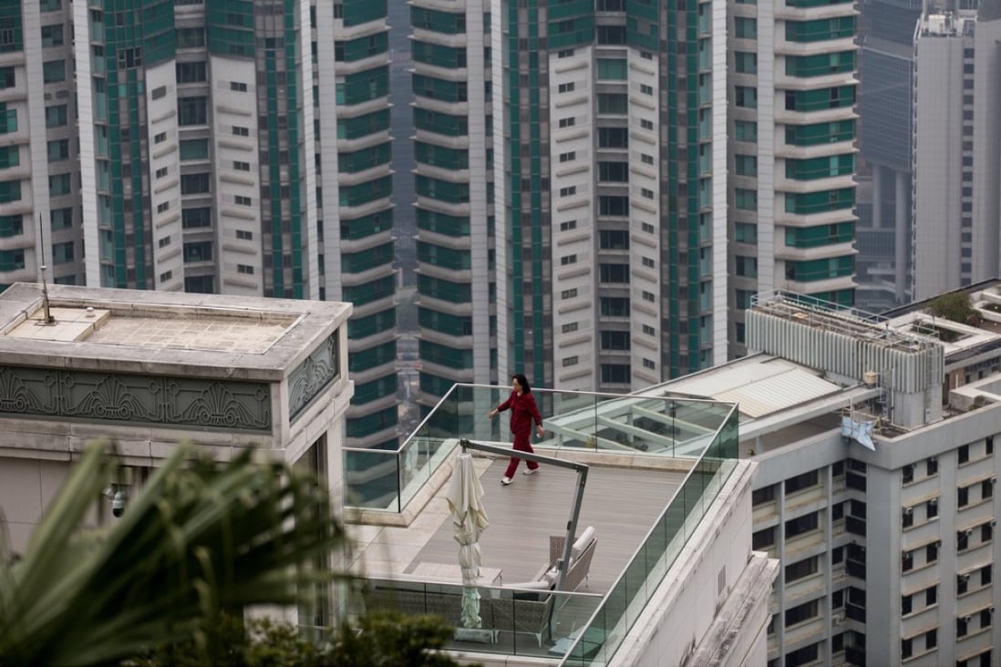 A woman exercises on the terrace of one of seven luxury units situated at 28 Barker Road, an exclusive residential area of The Peak, in Hong Kong. Photo: EPA-EFE