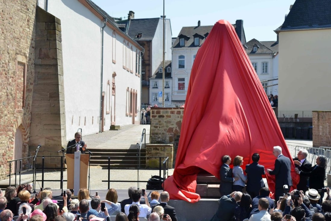 Visitors look on as a statue of German revolutionary thinker Karl Marx is unveiled. Photo: AFP
