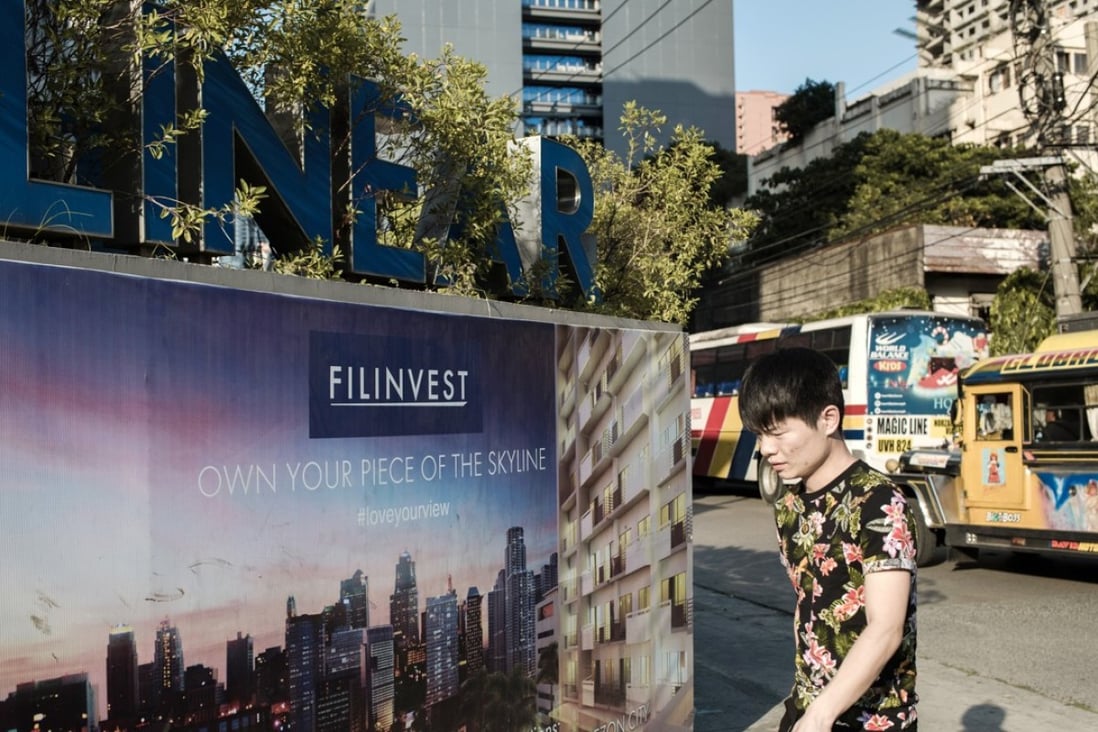 A pedestrian walks past The Linear Makati development in the San Antonio Village area of Makati City, Manila. In the Bay Area close to Makati, home prices surged by a record 27 per cent in the last three months of 2017. Photo: Bloomberg