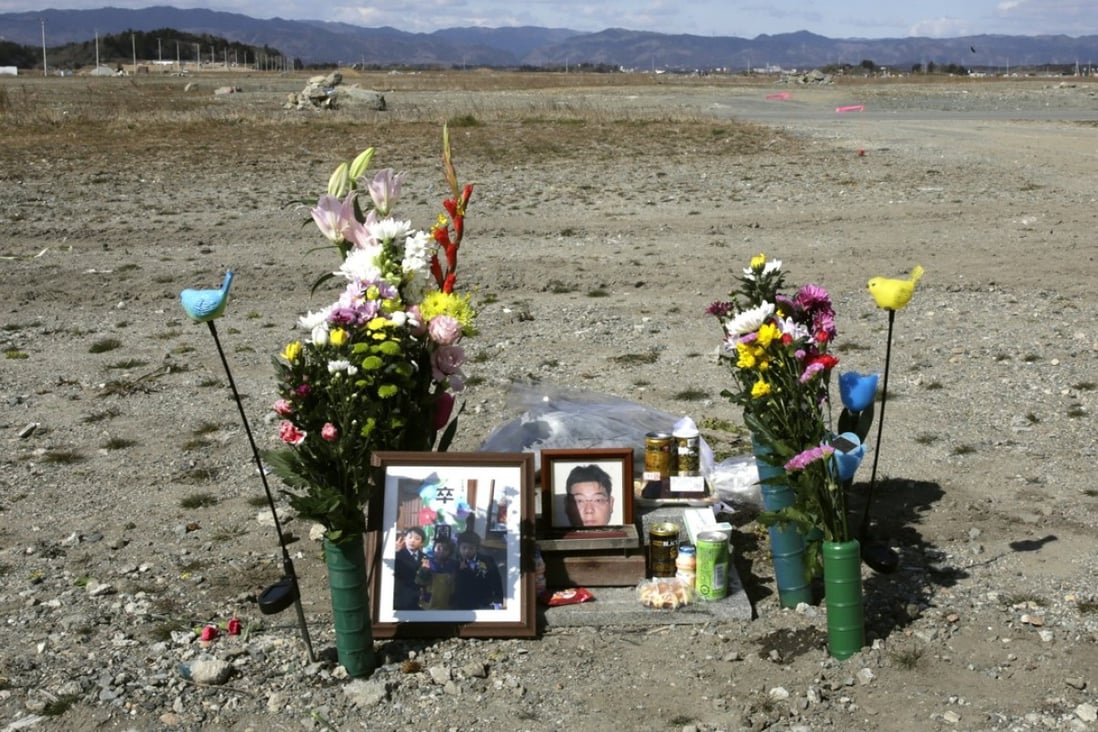 Flowers and photos are placed where the Ukedo Post Office stood in Fukushima, Japan, before the tsunami struck the area in 2011. Photo: EPA