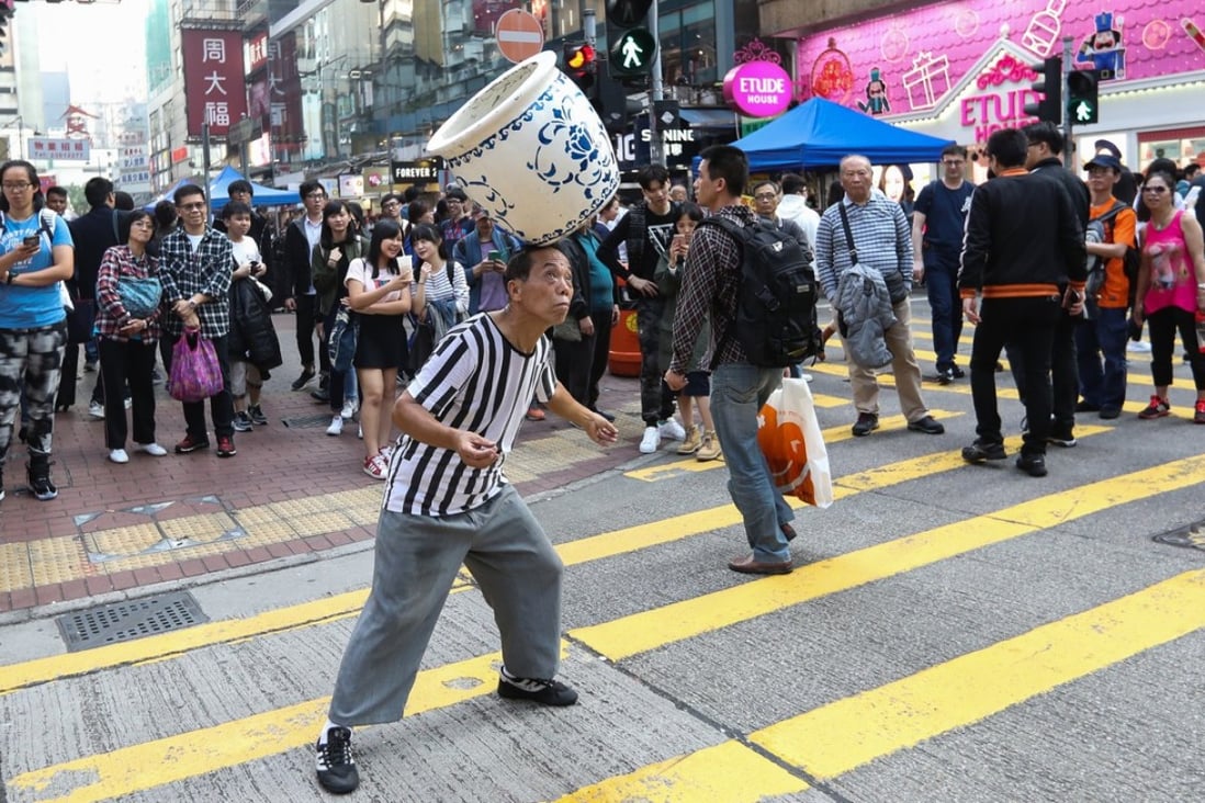 A stretch in popular Mong Kok is famous for street performers, but the fight for space has resulted in congested streets. Photo: Edward Wong