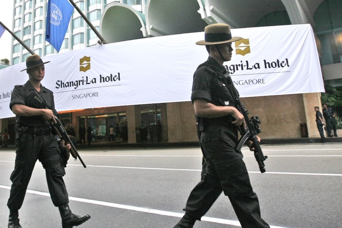 Singapore police officers patrol outside the Shangri-La hotel. Photo: AP