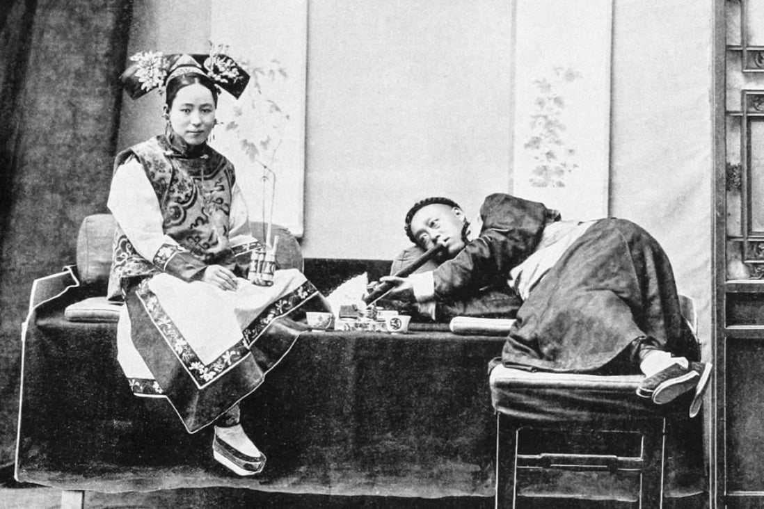 A man smokes opium in Peking, with an attendant holding a tobacco pipe, circa 1905. Picture: Alamy