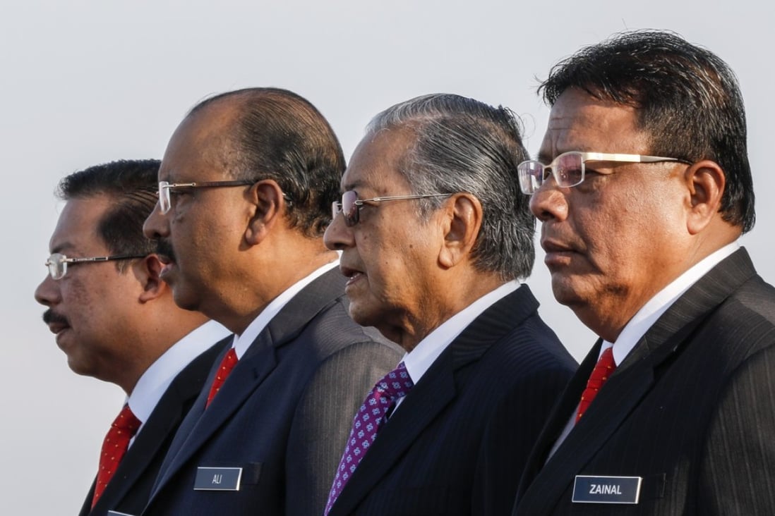 Malaysian’s new Prime Minister Mahathir Mohamad (2-R) sings the national anthem at the prime minister’s office in Putrajaya. Photo: EPA