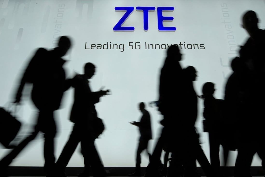 People walking in front of the ZTE stand at the Mobile World Congress (MWC), the world's biggest mobile fair, in Barcelona. Photo: AFP
