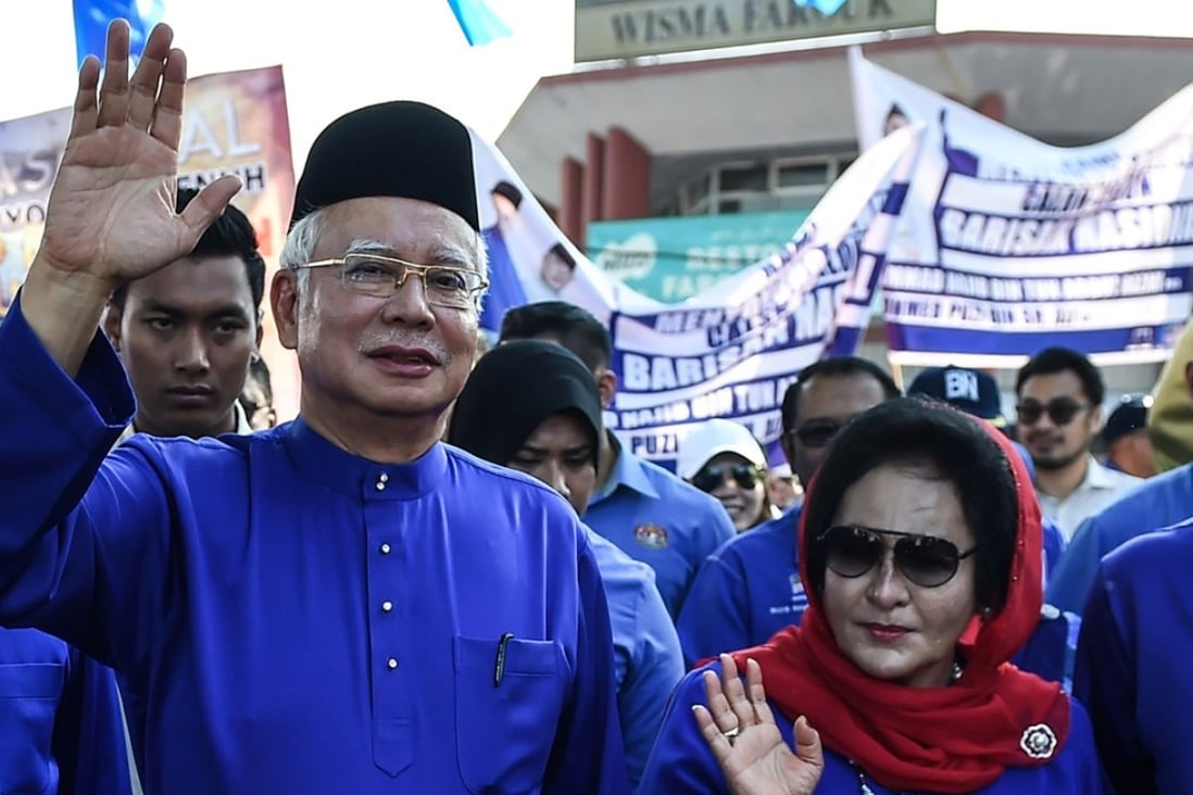 Najib Razak and his wife Rosmah Mansor waving as they arrive at a nomination centre to hand over election documents in Pekan, Malaysia. Photo: AFP
