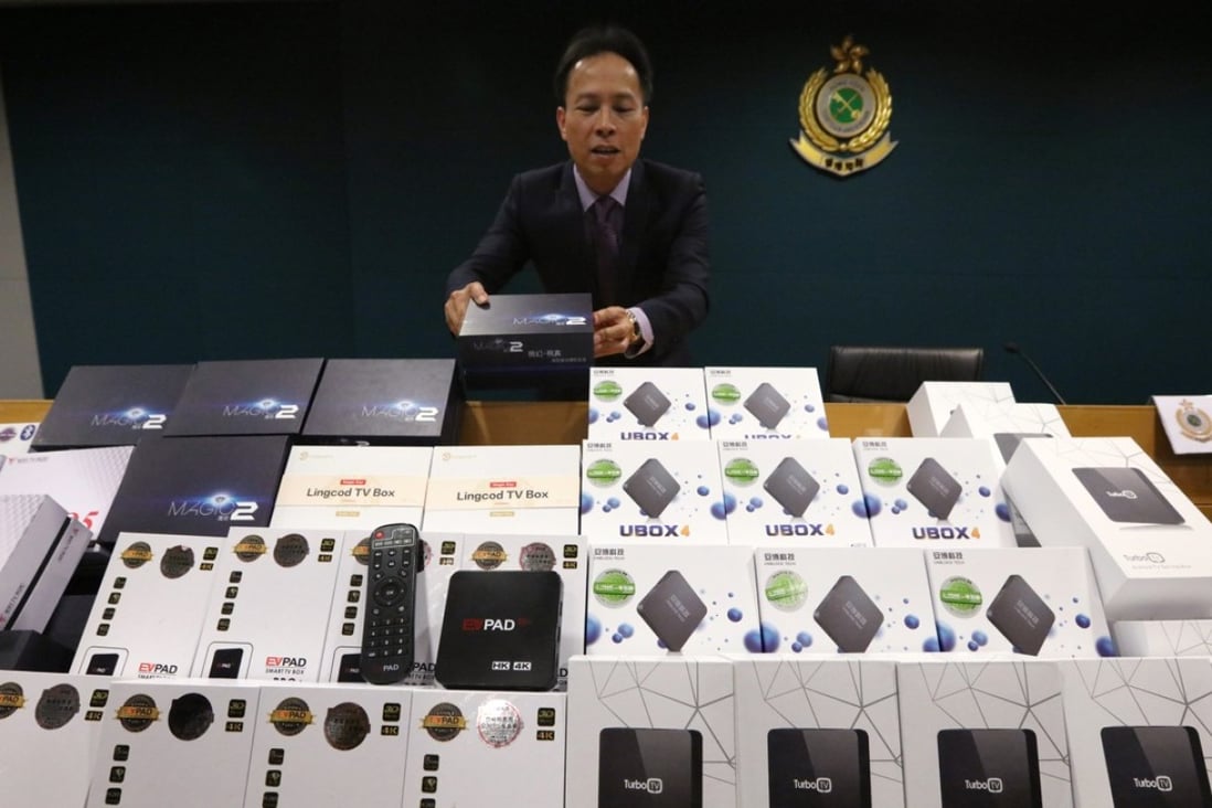 Fong with some of the set-top boxes that were seized in the weekend raids. Photo: Felix Wong