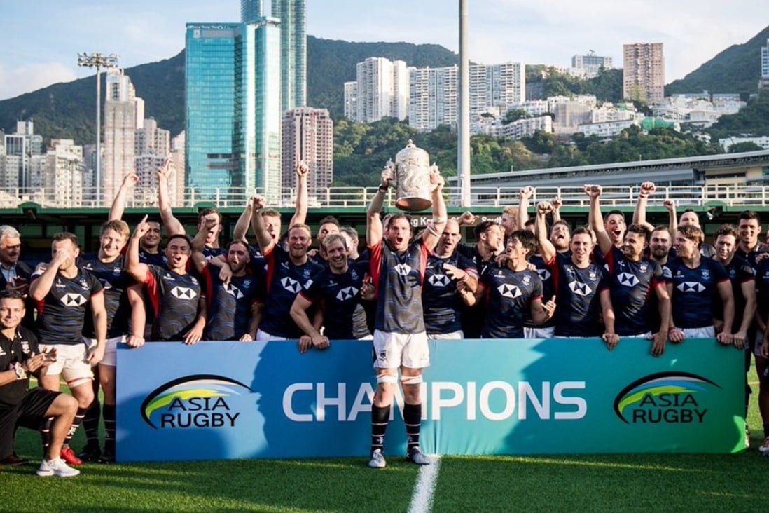 Hong Kong captain James Cunningham lifts the Asian Rugby Championship trophy at Hong Kong Football Club. Photo: HKRU