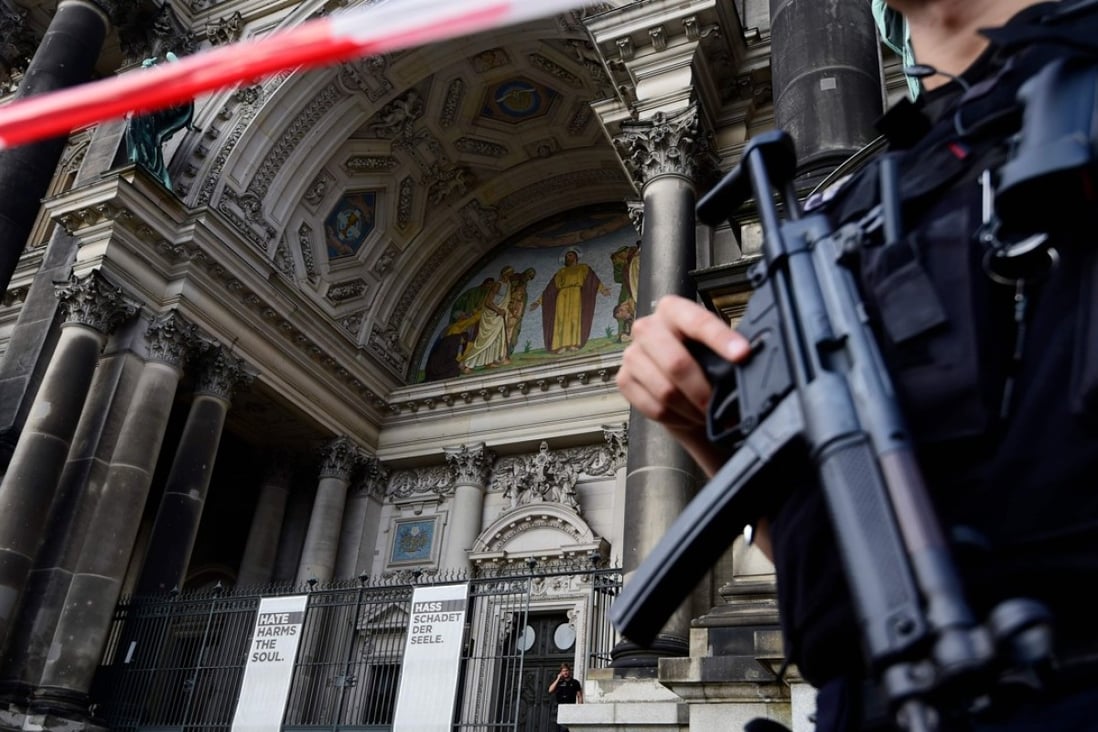 Armed Police cordon off Berling Cathedral in Berlin on Sunday after police say they shot a knife-wielding man who was “rampaging” there. Photo: AFP