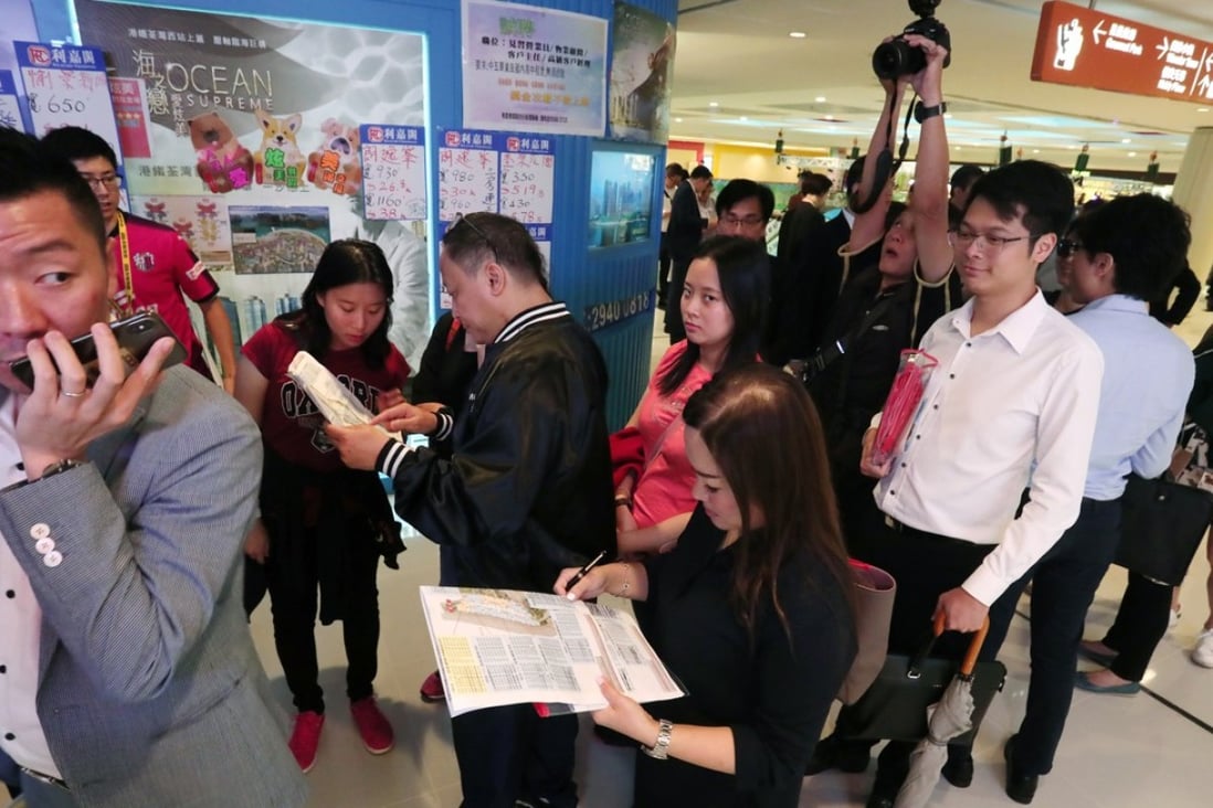 Homebuyers queue on Wednesday for a chance to assess the flats on offer at Fleur Pavilia, a luxury development in North Point by New World Development. Photo: Jonathan Wong