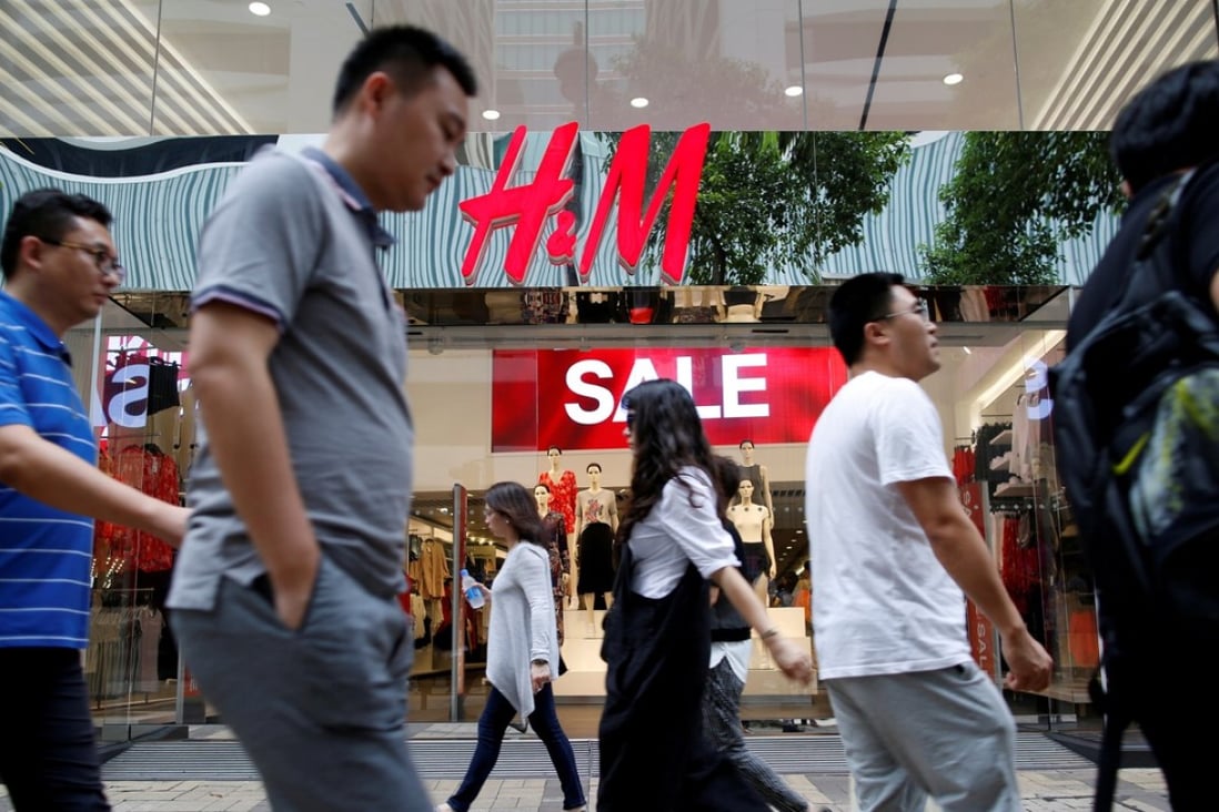 People walk past a H&M fashion chain store in Tsim Sha Tsui, Hong Kong. Photo: Reuters