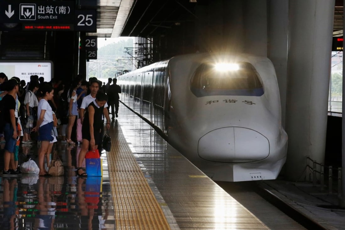 Passengers wait on the platform as a high-speed train approaches at Hangzhou East railway station in Zhejiang province, China. Photo: Bloomberg