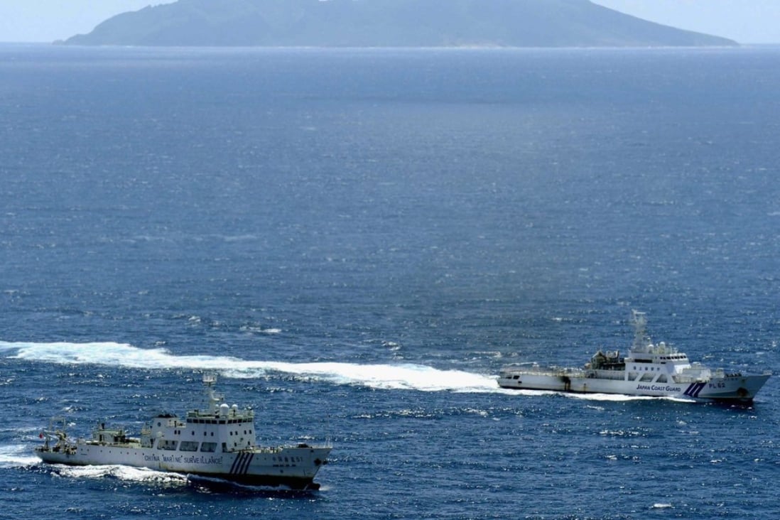 A file picture of a Chinese marine surveillance ship (left) pictured near one of the disputed Diaoyu Islands in the East China Sea as a Japanese Coast Guard vessel watches on. Photo: Kyodo