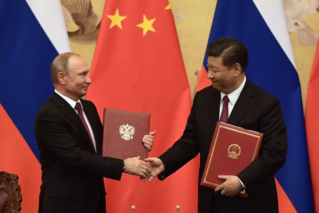 Russian President Vladimir Putin and his Chinese counterpart Xi Jinping shake hands during a signing ceremony in Beijing on Friday. Photo: AFP