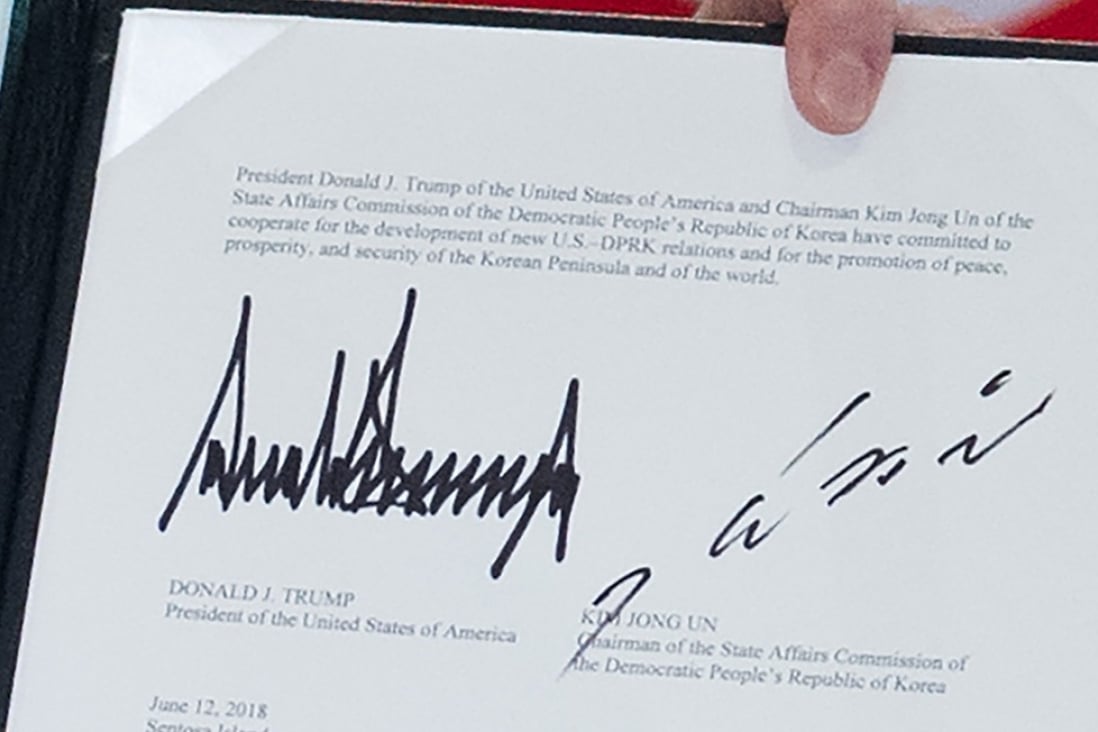 The signatures of US President Donald Trump (L) and North Korea's leader Kim Jong-un seen on the joint statement during Tuesday’s summit in Singapore. Photo: AFP