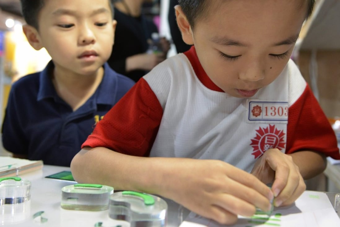 A boy stamps a Chinese character during an exhibition in Taipei. Taiwan, Macau and Hong Kong are the few places where traditional characters are widely used when writing Chinese. Photo: AFP
