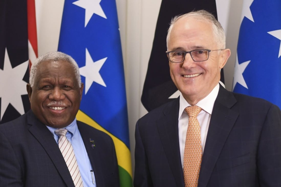 Prime Minister of the Solomon Islands Rick Houenipwela and Australian Prime Minister Malcolm Turnbull shake hands ahead of a bilateral meeting in Canberra. Australia has stepped in to majority fund an undersea high-speed communications cable to the Solomon Islands. Photo: AFP