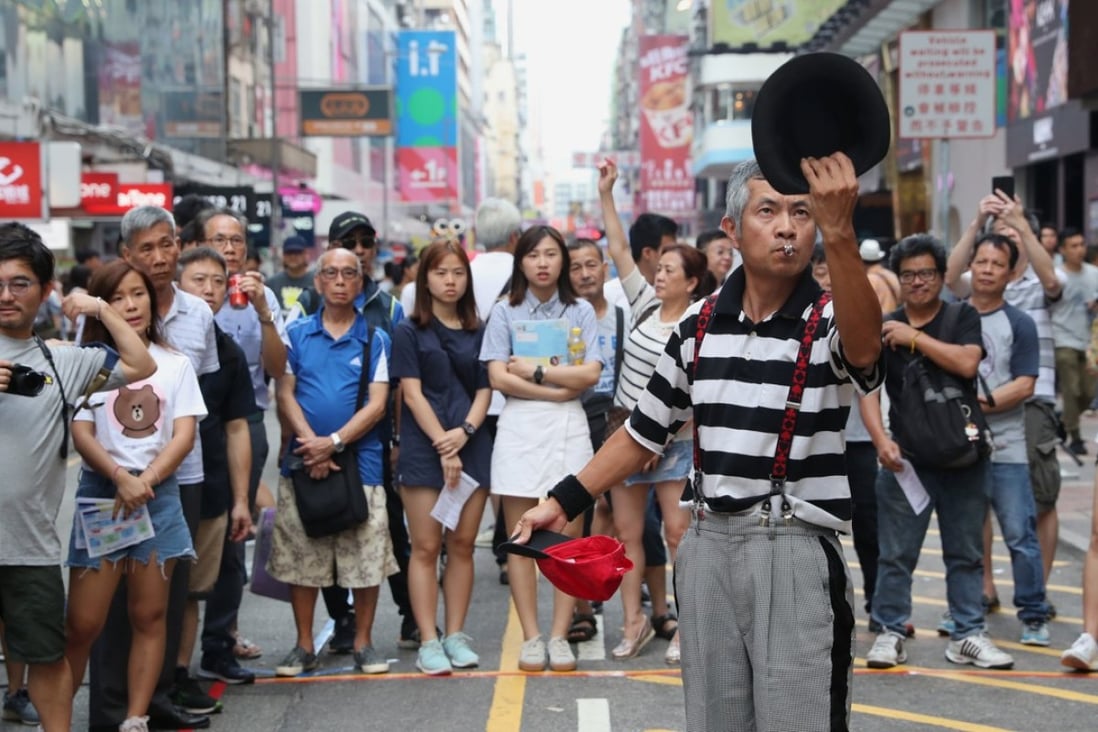 Street performer Andrew So, aka Mr Funny, performs at Sai Yeung Choi Street South in Mong Kok on June 3. Photo: K.Y. Cheng