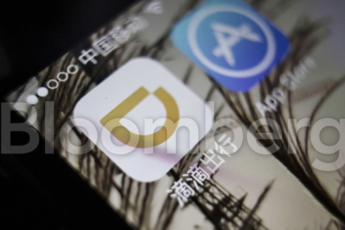 The icon for Didi Chuxing application, left, is displayed on a smartphone screen in this arranged photograph taken in Shanghai, China, on Sunday, May 22, 2016. Photographer: Qilai Shen/Bloomberg