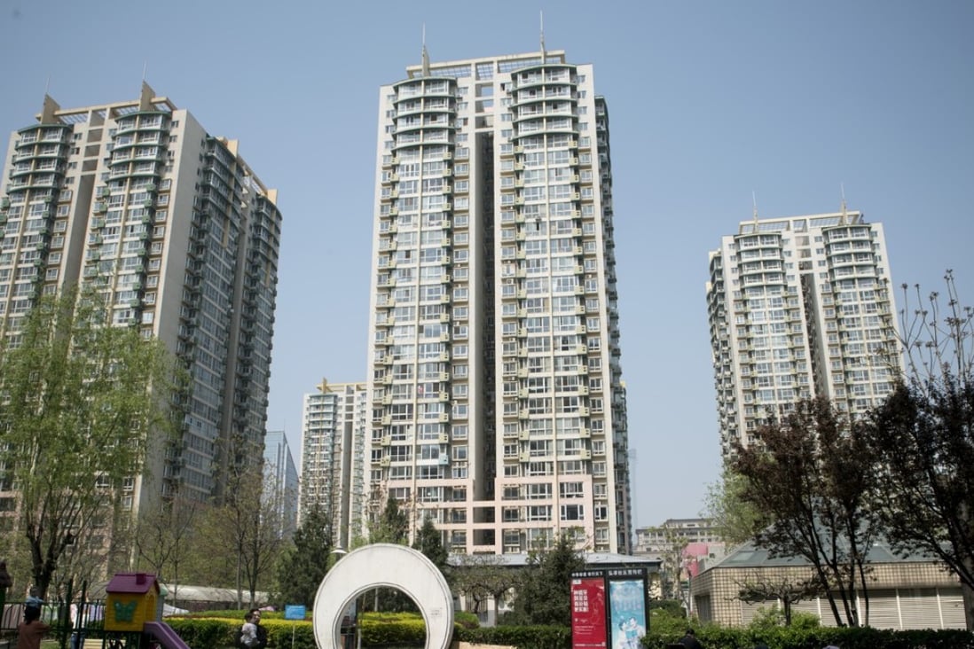 Sixty-one of 70 cities tracked showed price gains in May, reflecting a reacceleration in home price inflation. Residents stand at a playground in front of apartment buildings in the Shuangjing area of Beijing. Photo: Bloomberg