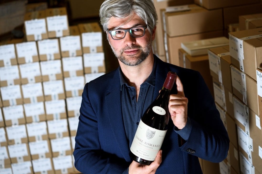 In this file photo taken on April 27, 2018 Auction house Baghera Wines executive director Michael Ganne poses in Geneva with a bottle of Vosne-Romanee 1er cru Cros Parantoux wine by late famous French winemaker Henri Jayer. Photo: Agence France-Presse