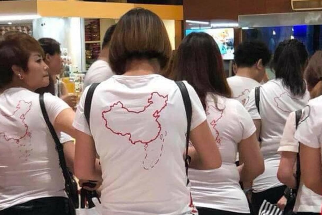 A photo of Chinese tourists wearing T-shirts bearing Beijing’s controversial “nine-dash line” at Vietnam’s Cam Ranh International Airport in May went viral, sparking anger and calls for a China-specific code of conduct. Picture: Twitter / Nga Pham