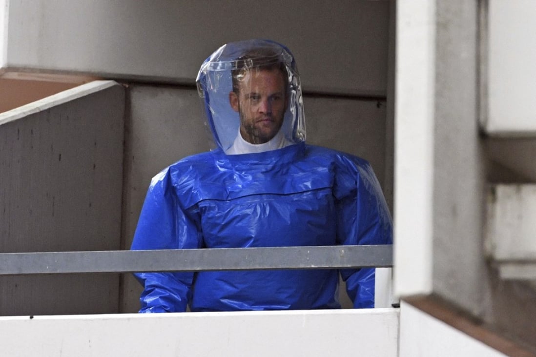 A German police officer in protective gear at the scene of the raid. Photo: AP