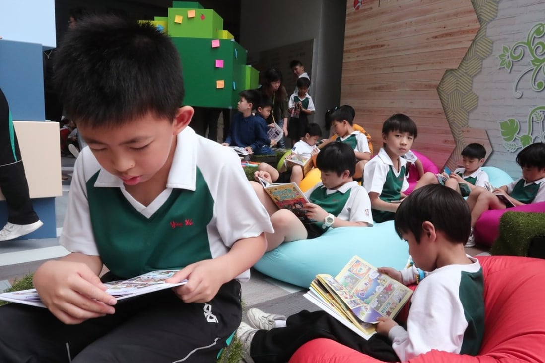 Students read at the Leisure and Cultural Services Department’s “My Pop-up Library” event on World Book Day on April 21 at a school in Sham Shui Po. The Hong Kong Public Library’s decision to move 10 children’s books featuring same-sex parents and other LGBT themes to the closed stack section has come in for criticism. Photo: Jonathan Wong