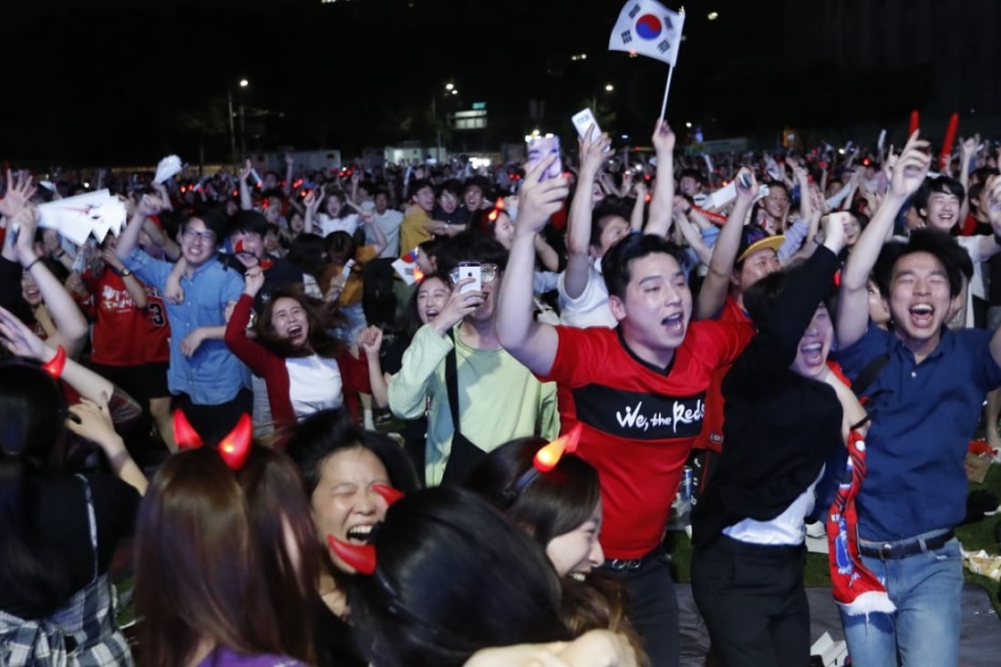 South Korea fans celebrate in front of the Seoul city hall, watching their team beating Germany in the World Cup. Photo: EPA