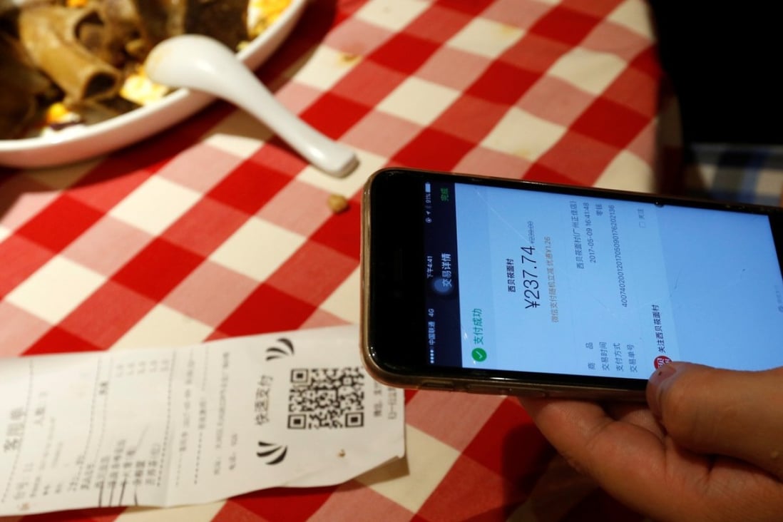 A customer uses WeChat Pay to pay the bill inside a restaurant in China. Photo: Reuters