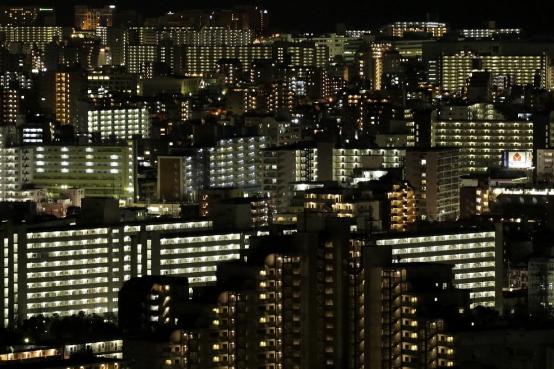 Residential buildings stand illuminated at night in Tokyo, Japan. Photo: Bloomberg
