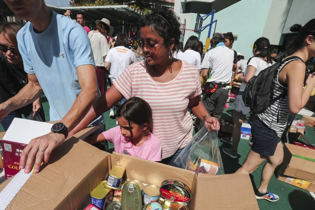 Some 200 Hong Kong families took part in a community service marathon at Kennedy School in Pok Fu Lam on May 5, in which they helped to pack food for people in need. Photo: Jonathan Wong