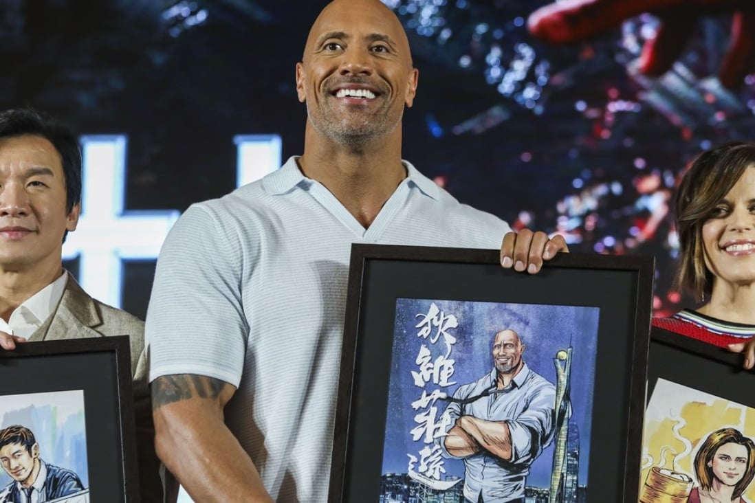 Skyscraper stars Chin Han, Dwayne Johnson and Neve Campbell with sketches of themselves presented to cast members at their appearance in Hong Kong ahead of the film’s opening in the city next week. Photo: Sam Tsang