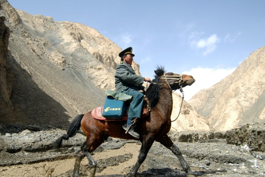 A postman goes on his rounds in the Pamir Mountains in the remote western region of China, serving more than 5,000 nomads across 2,200 sq km, in March 2012. The Universal Service Obligation strives to ensure that everyone has access to postal services. Photo: Xinhua 