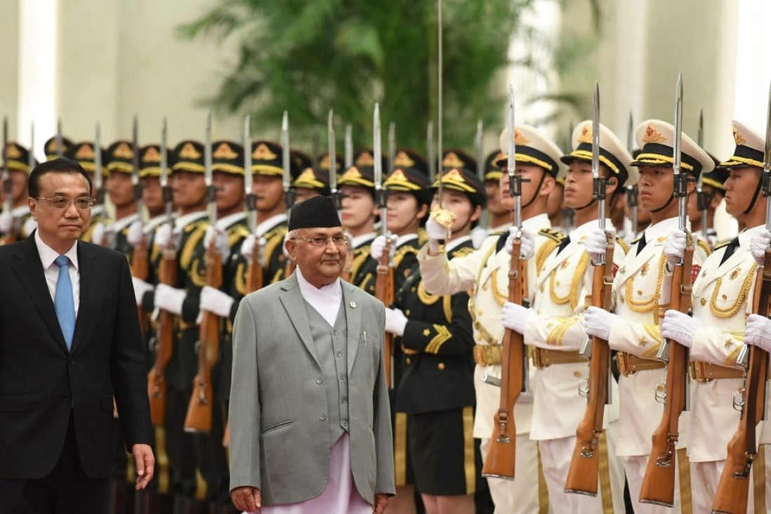 Nepalese Prime Minister K P Sharma Oli (centre) and Chinese Premier Li Keqiang review a military guard of honour during a welcome ceremony at the Great Hall of the People in Beijing on June 21. Nepal and China signed eight agreements during the visit. Photo: AFP