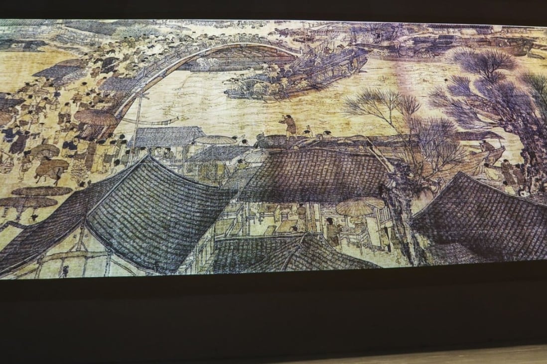 Visitors watch an interactive digital display of a masterpiece, the scroll painting Along the River During the Qingming Festival by 12th-century painter Zhang Zeduan at the Palace Museum in Beijing, China, on July 05, 2018. The painting, now housed in the Palace Museum, gives a panoramic portrayal of flourishing urban life in Bianliang (today's Kaifeng, Henan province), the capital during the Northern Song period (960-1127). Visitors can experience a moment of life in Song dynasty during this interactive show. 05JUL18 SCMP/Simon Song