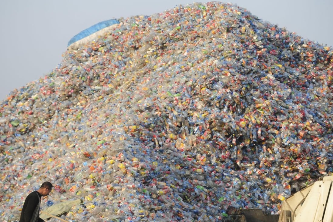 A worker inspects plastic for recycling at a factory in Wuhan, in Hubei province, China in 2010. Picture: Alamy