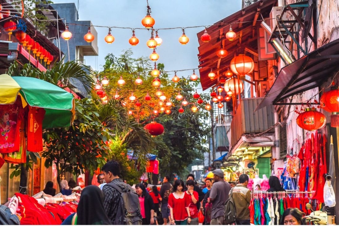 A walkway with hanging lamps and lanterns in Jakarta’s Old Town district. Photo: Alamy