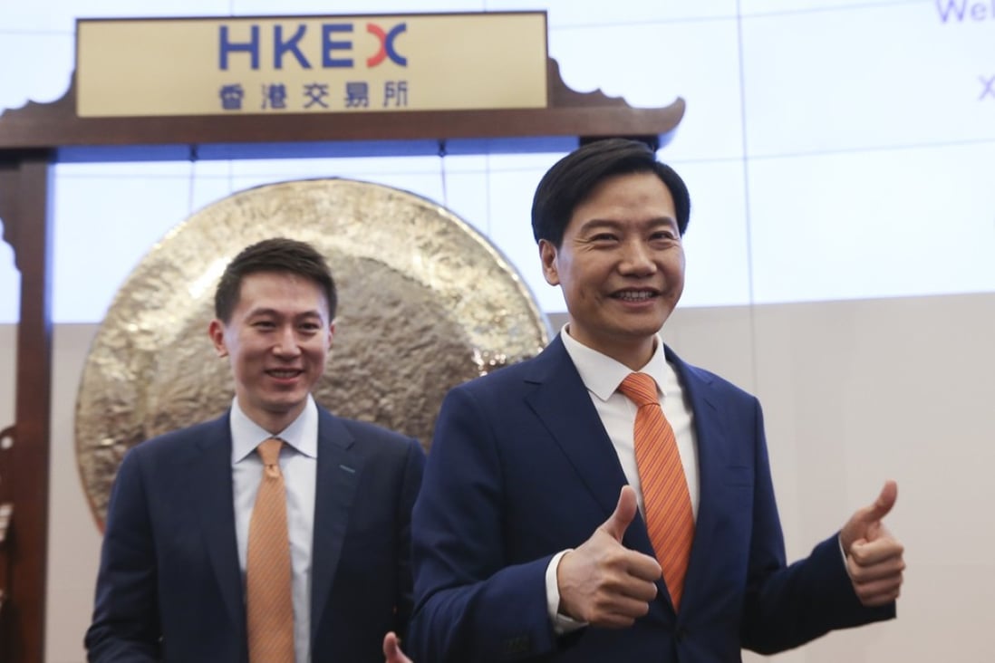 Xiaomi’s chief financial officer Chew Shouzi (left) and CEO Lei Jun at the company’s listing ceremony at the Hong Kong stock exchange on Monday. The stock will be added to the Hong Kong Composite Index with effect from July 23. Photo: Sam Tsang