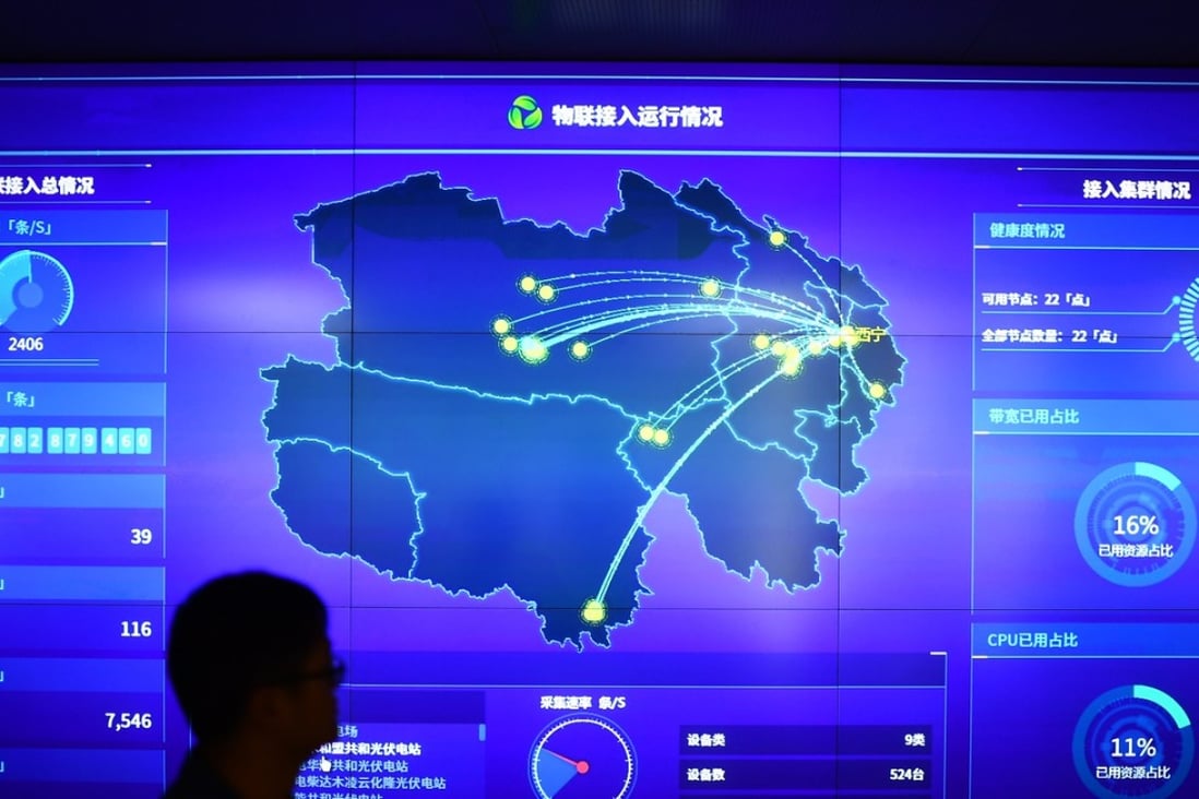 A staff member walks past a data screen at a new energy and big data branch of the State Grid Qinghai Electric Power Company in Xining, northwest China. Photo: Xinhua