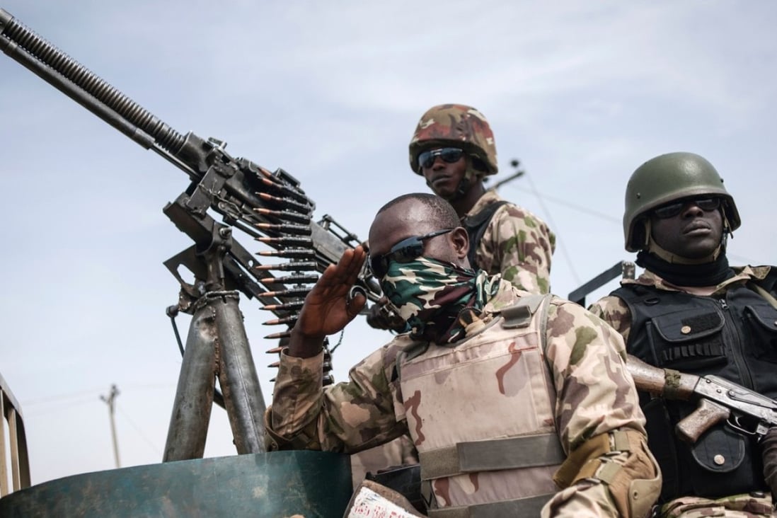 Soldiers from the 7th Division of the Nigerian Army on the back of a vehicle in Damboa, Borno State northeast Nigeria on March 25, 2016. Photo: Agence France-Presse