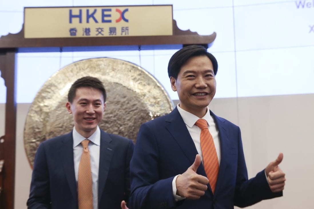 Xiaomi’s chief financial officer, Chew Shouzi, left, and chief executive, Lei Jun, during its listing ceremony at Hong Kong stock exchange last week. Photo: Sam Tsang