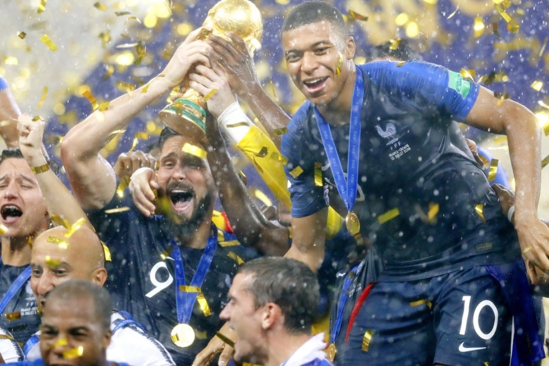 Olivier Giroud, alongside Kylian Mbappe, raises the trophy after France beat Croatia 4-2 to win the country’s second World Cup at Luzhniki Stadium in Moscow. Photo: Kyodo