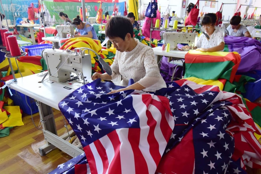 This July 13, 2018 photo shows Chinese employees sewing US flags in Fuyang in Anhui province. As the Sino-US trade war rages, a factory set amid corn and mulberry fields in central China stitches together US and "Trump 2020" flags -- and business is good. Photo: AFP