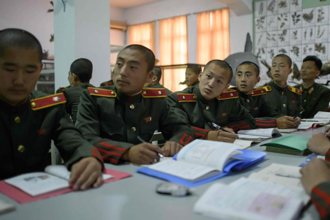 In a photo taken on June 14, 2018 students attend a biology class at the Mangyongdae Revolutionary School outside Pyongyang. Mangyongdae Revolutionary School for boys was originally set up by the North's founder Kim Il Sung to educate the orphans of those killed in the fight against Japanese colonial rule, it has evolved to become the country's top school, and one of the institutions that knits the ruling elite together. / AFP PHOTO / Ed JONES / TO GO WITH AFP STORY NKOREA-EDUCATION-POLITICS-SOCIAL,FEATURE BY SEBASTIEN BERGER