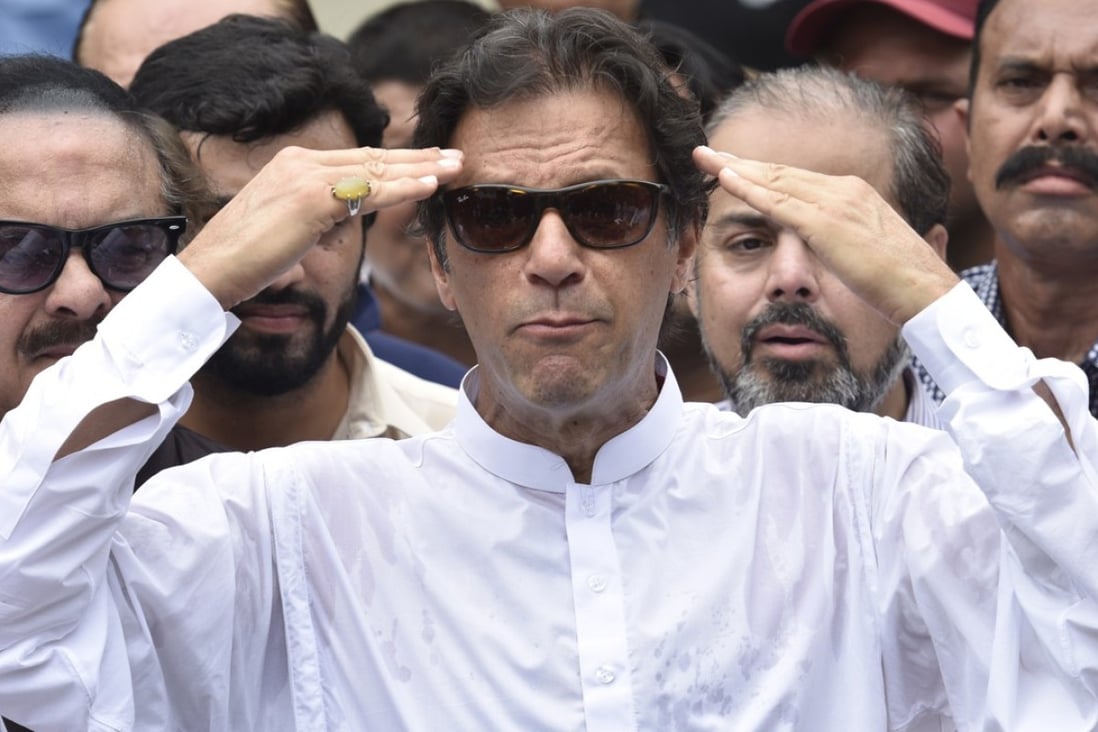Imran Khan, head of Pakistan Tehrik-e-Insaf (PTI) speaks to journalists after casting his ballot at a polling station during general elections in Islamabad on Wednesday. Photo: EPA