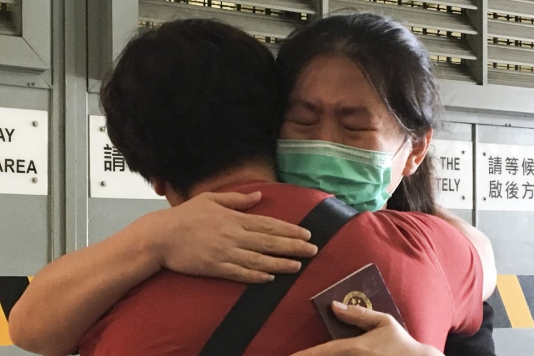 Li Dandan (in mask) hugging her mother following her release, outside the High Court in Admiralty. Photo: Jasmine Siu