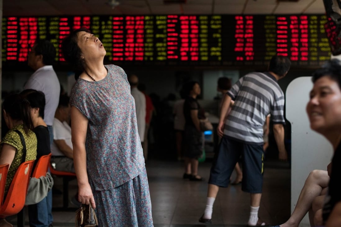 Investors monitor stock market movements at a brokerage house in Shanghai. Photo: AFP